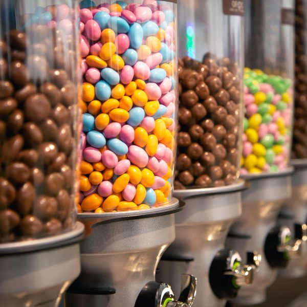 Bright candies in containers by weight in a candy store.