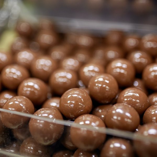 close up of chocolate dragee candies in box