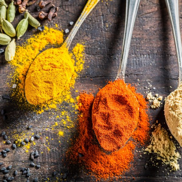 Closeup of colorful condiments on old wooden table